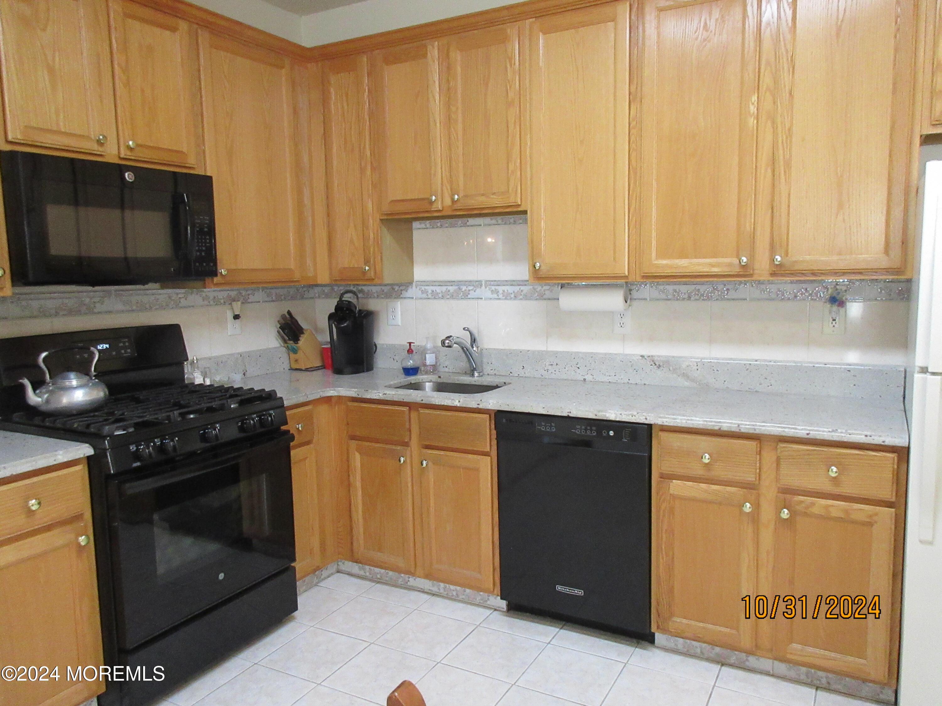 112 Riva Boulevard, Unit 1237 Brick, NJ 08723 - Photo 5 of 46 a kitchen with stainless steel appliances granite countertop a stove a sink and a microwave