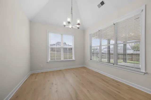 a large kitchen with stainless steel appliances granite countertop a lot of counter space and wooden floor