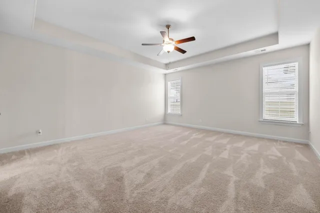 a large bathroom with a granite countertop double vanity sink a mirror and a bathtub