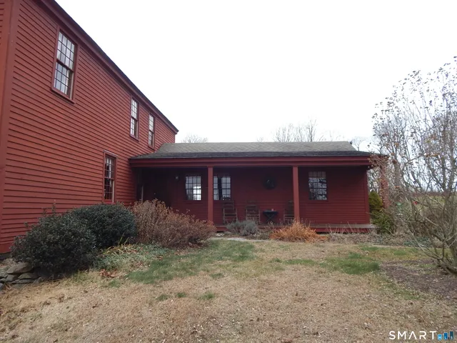 a view of a house with large windows and a small yard