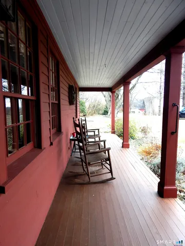 a view of a patio with wooden floor and iron stairs