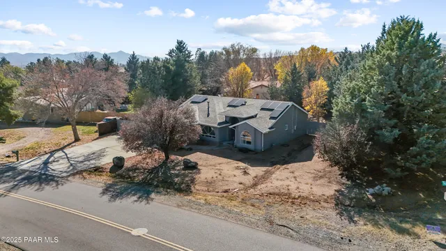a front view of a house with a yard covered with snow