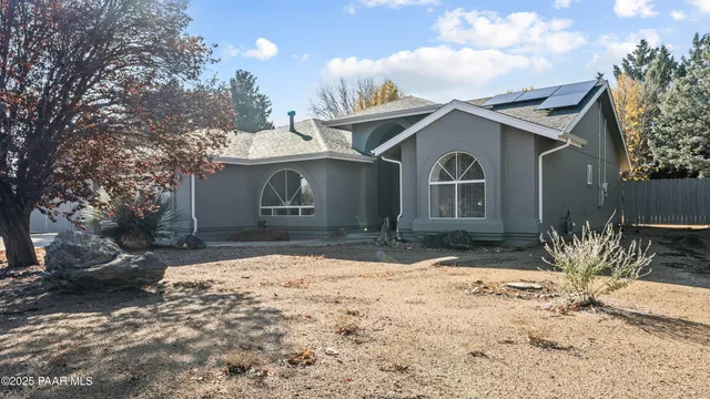 a living room with furniture and a ceiling fan