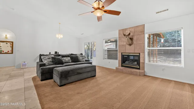 a dining room with furniture and a floor to ceiling window