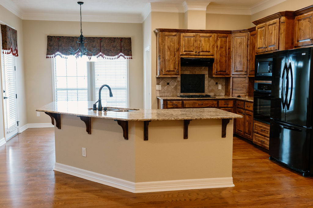 1909 Debbie Drive Bryan, TX 77802 - Photo 12 of 34 a kitchen with stainless steel appliances granite countertop a refrigerator a stove and a sink