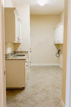 a utility room with cabinets washer and dryer
