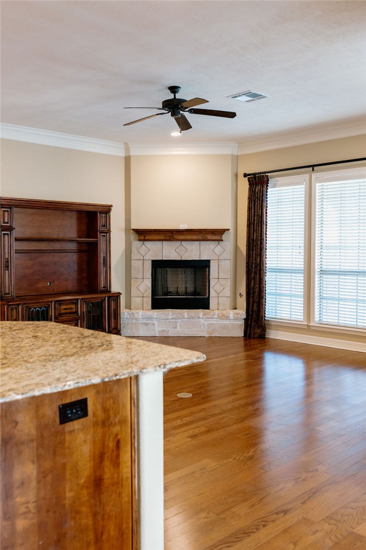 1909 Debbie Drive Bryan, TX 77802 - Photo 9 of 34 a living room with a fireplace and wooden floor