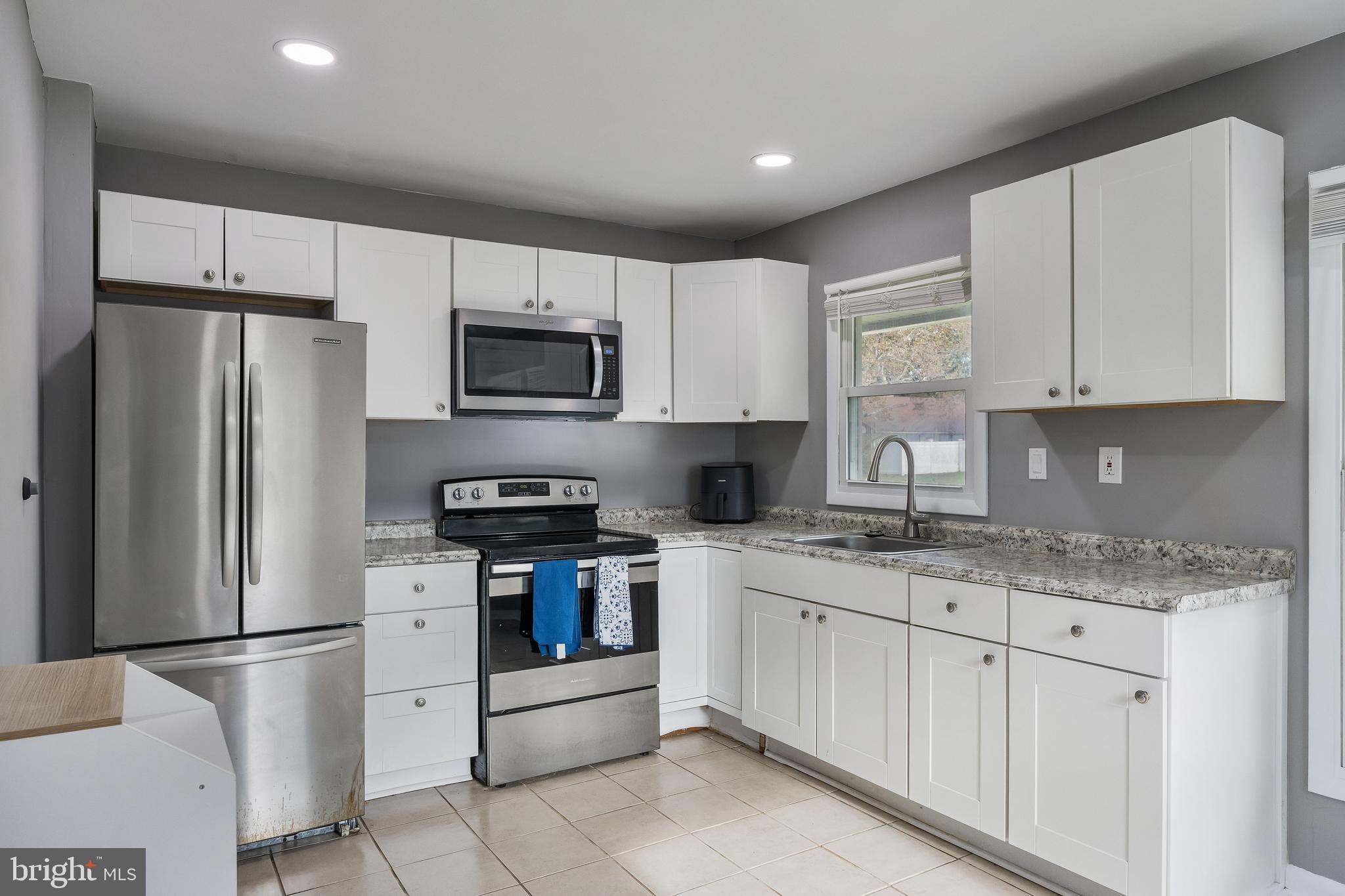 30 Babcock Lane Willingboro, NJ 08046 - Photo 9 of 35 a kitchen with stainless steel appliances granite countertop a refrigerator sink stove microwave and cabinets