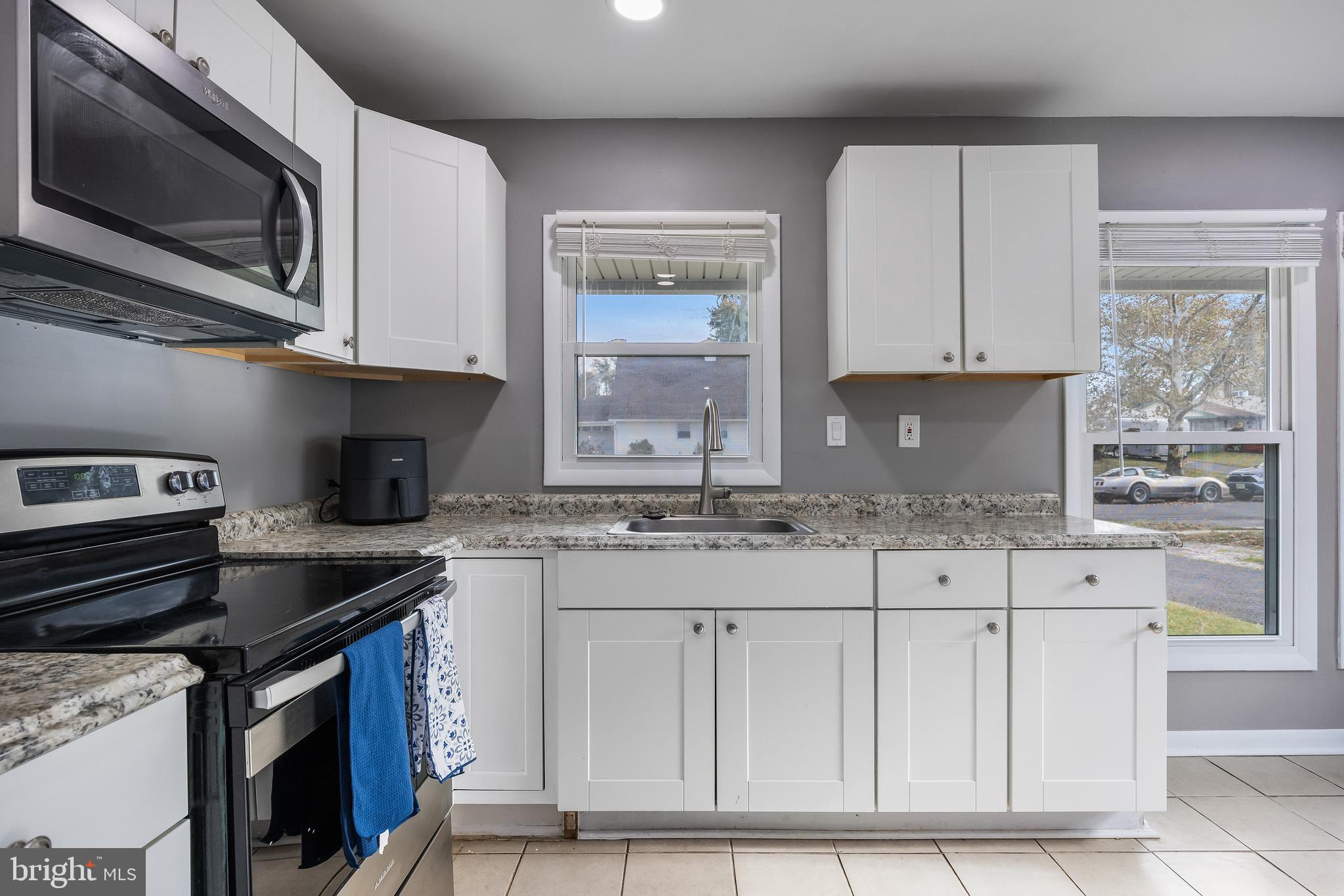 30 Babcock Lane Willingboro, NJ 08046 - Photo 10 of 35 a kitchen with stainless steel appliances granite countertop a stove a sink and a microwave