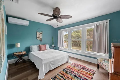 a bedroom with a bed and a large window