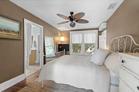 a bedroom with a large bed and a chandelier