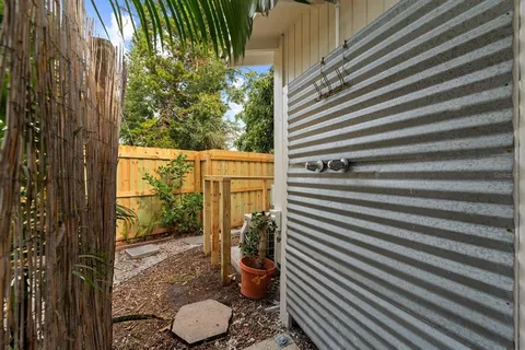 a view of a porch with furniture and next to a road