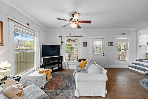 a living room with furniture and a flat screen tv