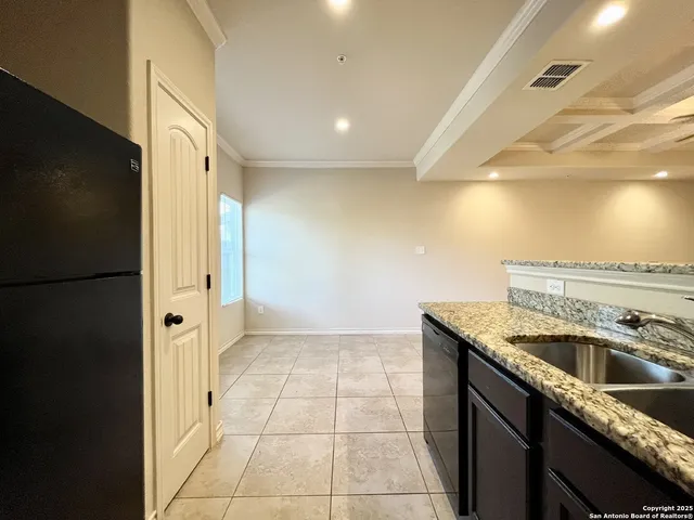 a kitchen that has a sink a refrigerator and a sink