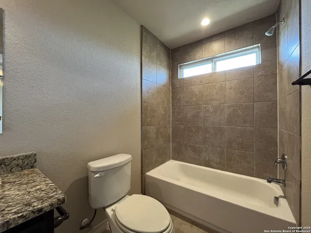 a bathroom with a toilet and a bathtub