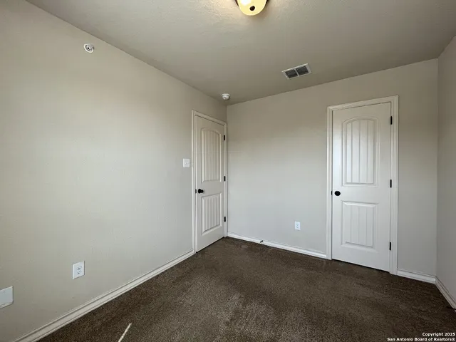 an empty room with closet area