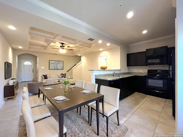 a large kitchen with a table and chairs