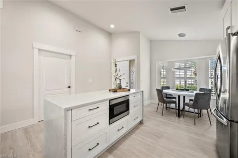 a view of kitchen with furniture and wooden floor