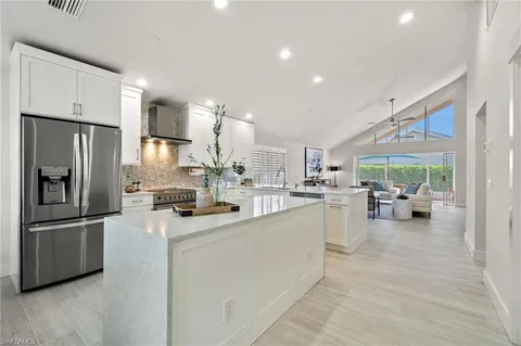 a kitchen with refrigerator and cabinets