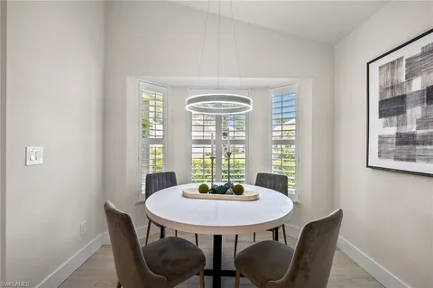 a view of a dining room with furniture and window