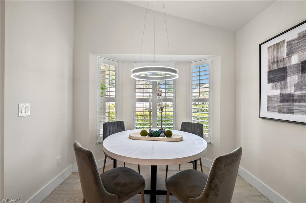 1590 Weybridge Circle, Unit 52 Naples, FL 34110 - Photo 14 of 36 a view of a dining room with furniture and window
