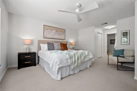 a bedroom with a bed and a couch