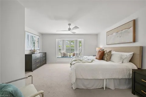 a spacious bedroom with a bed and a couch