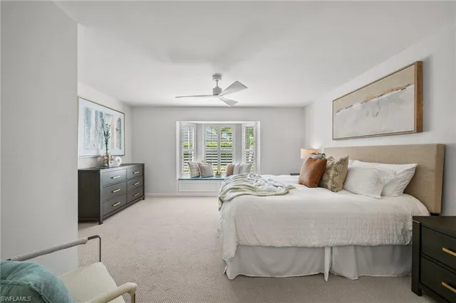 a spacious bedroom with a bed and a couch