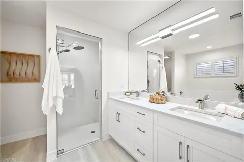 a bathroom with a double vanity sink mirror and double