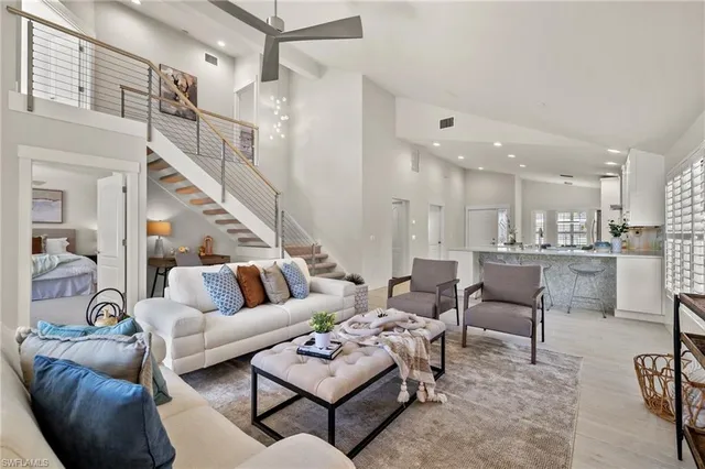 a living room with furniture and a view of kitchen