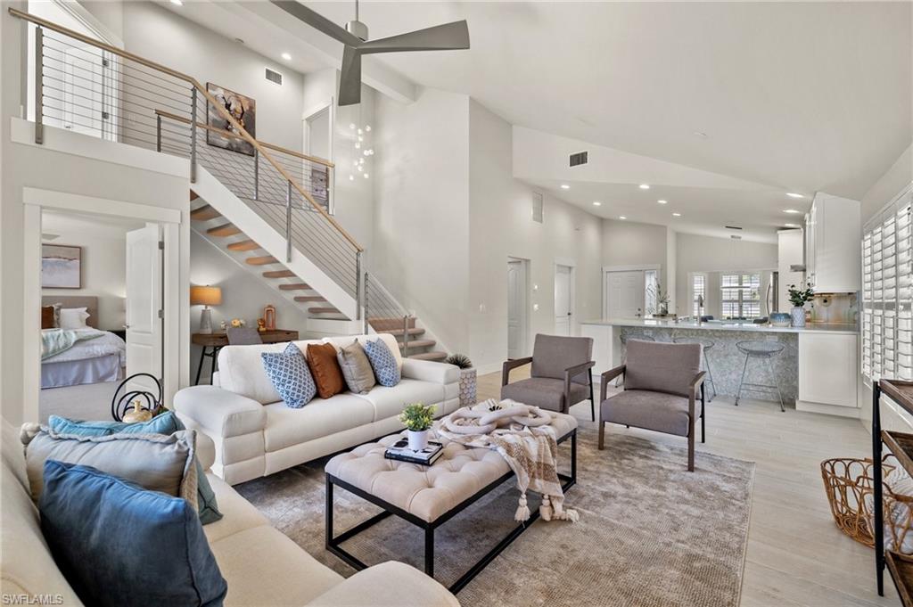 1590 Weybridge Circle, Unit 52 Naples, FL 34110 - Photo 2 of 36 a living room with furniture and a view of kitchen