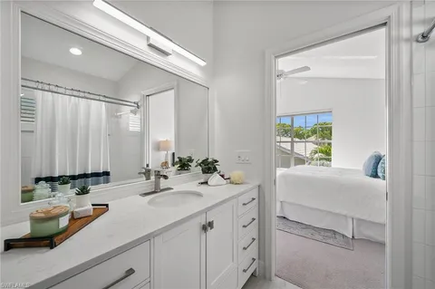 a bathroom with a sink a mirror and a window