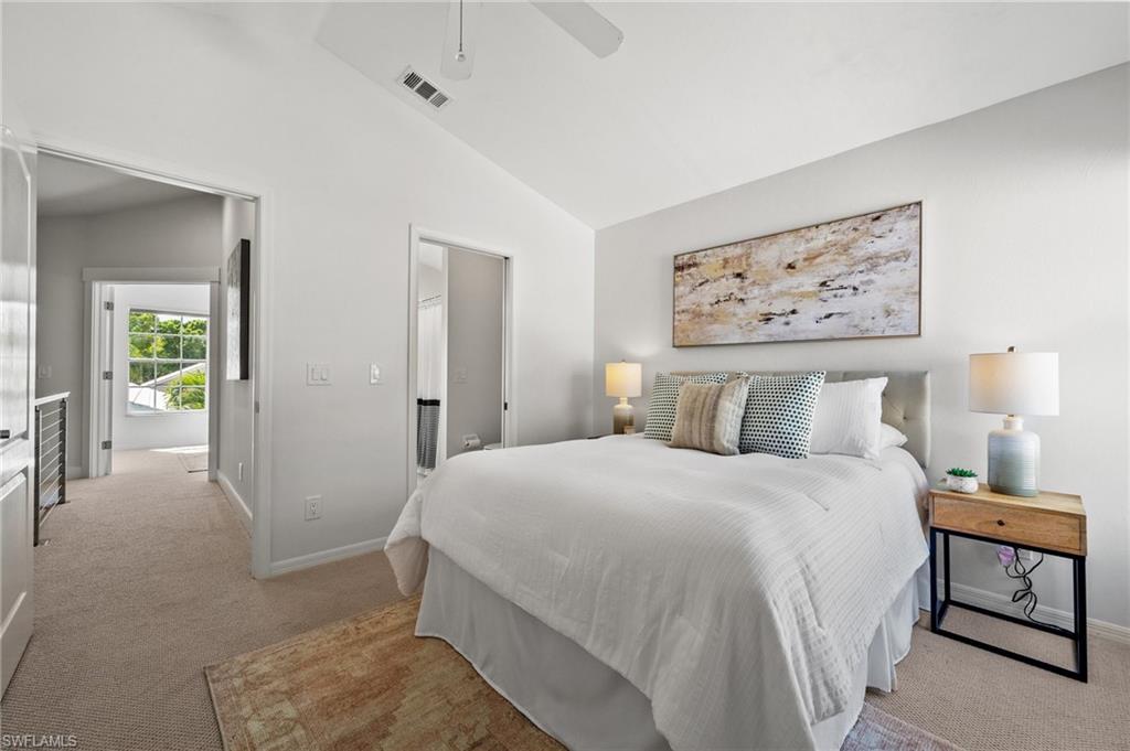 1590 Weybridge Circle, Unit 52 Naples, FL 34110 - Photo 26 of 36 a bedroom with a large bed and paintings on the wall
