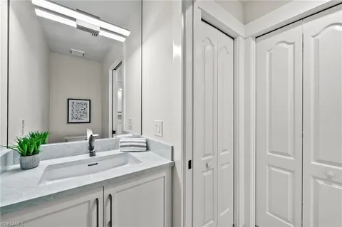 a bathroom with a double vanity sink and a mirror