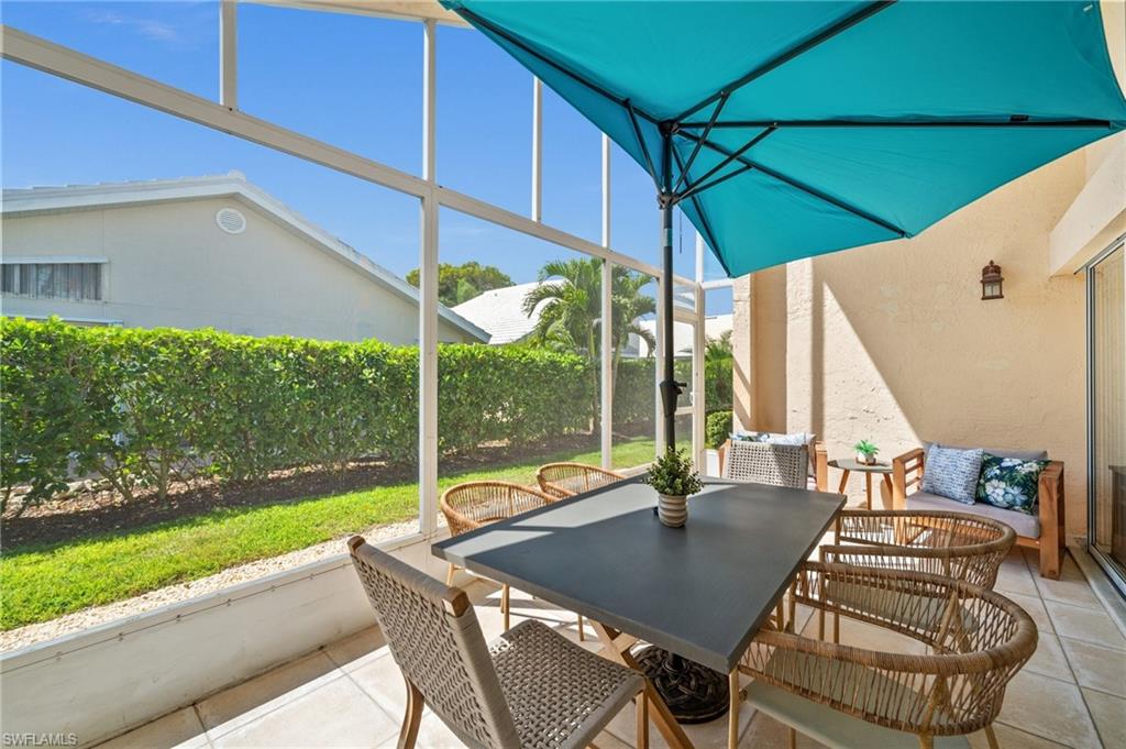 1590 Weybridge Circle, Unit 52 Naples, FL 34110 - Photo 31 of 36 a view of an outdoor sitting area with furniture