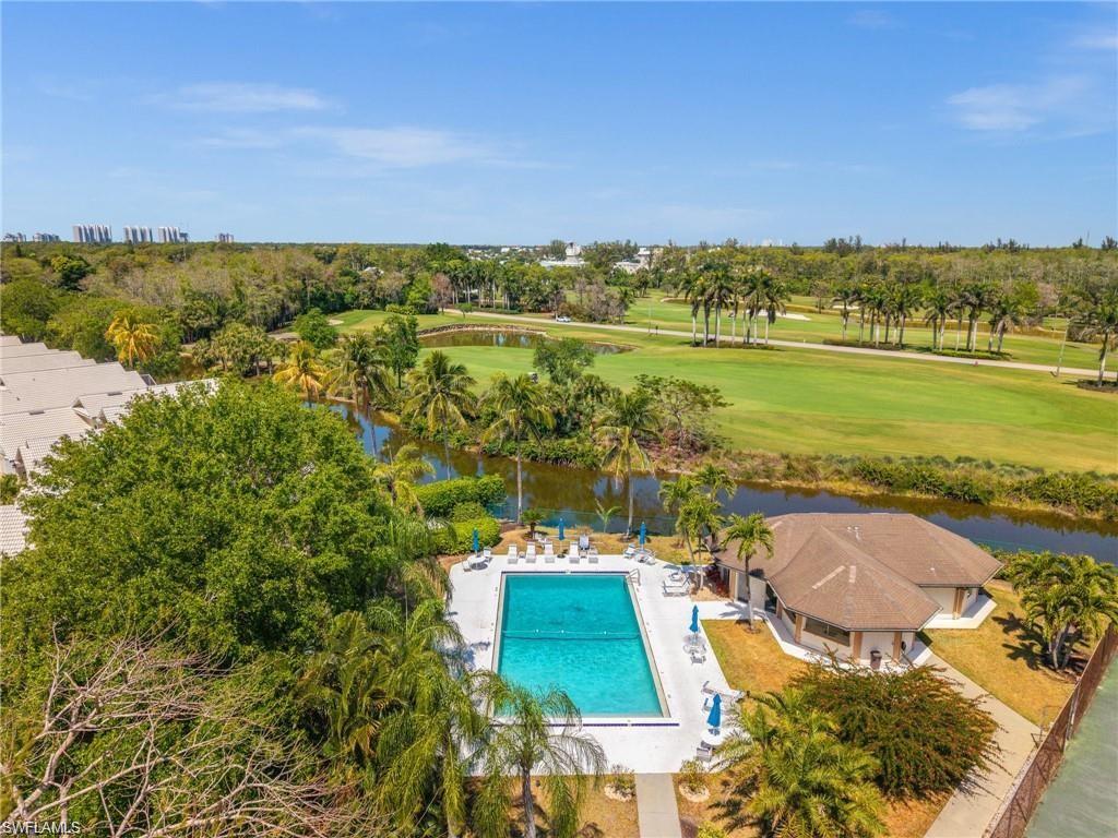 1590 Weybridge Circle, Unit 52 Naples, FL 34110 - Photo 35 of 36 aerial view of a city with lawn chairs