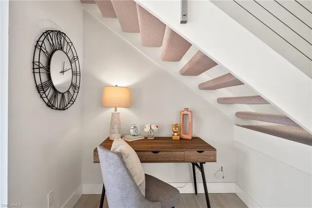 a view of a workspace room with furniture and chandelier