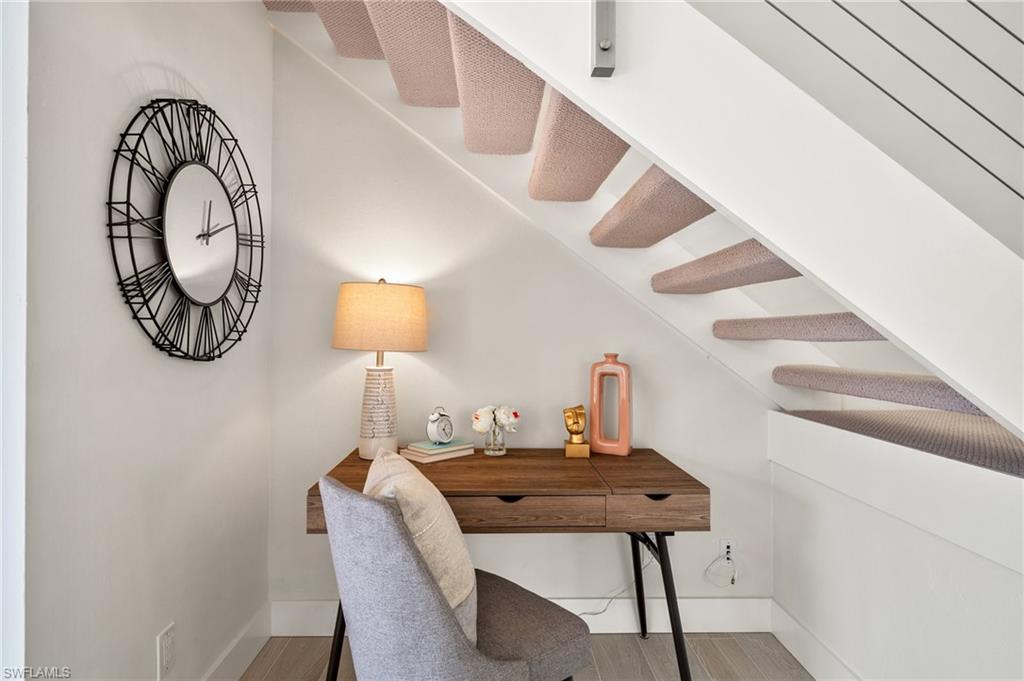 1590 Weybridge Circle, Unit 52 Naples, FL 34110 - Photo 6 of 36 a view of a workspace room with furniture and chandelier