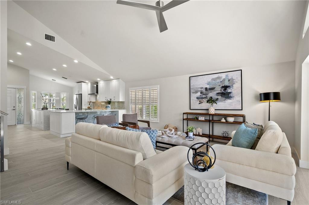 1590 Weybridge Circle, Unit 52 Naples, FL 34110 - Photo 7 of 36 a living room with furniture and a view of kitchen