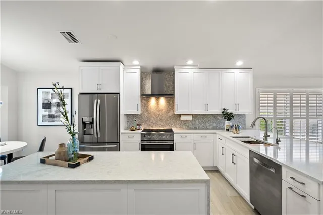 a kitchen with a refrigerator and a sink
