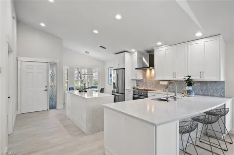 a kitchen with stainless steel appliances kitchen island granite countertop a sink and cabinets
