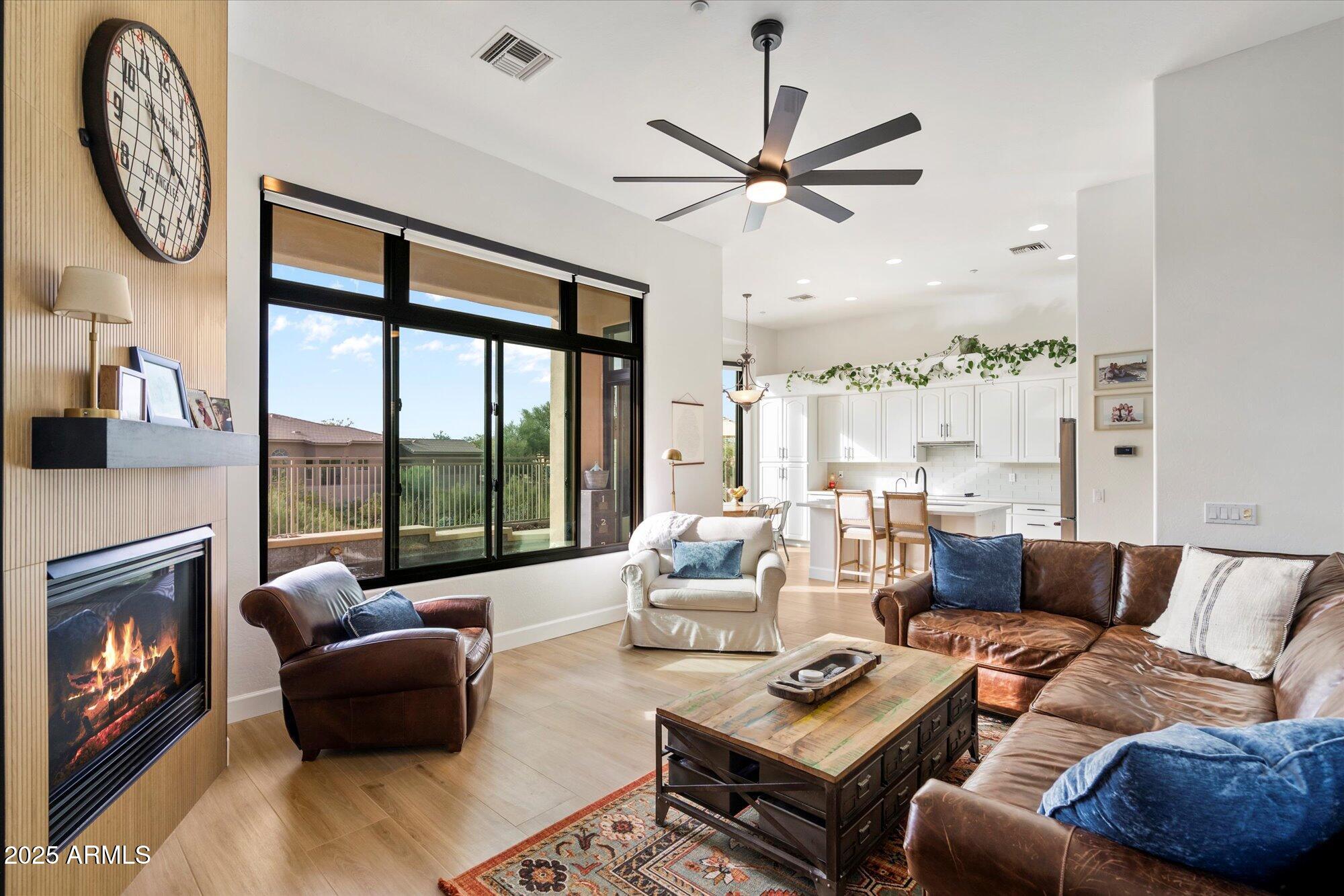 10747 East Greenway Road Scottsdale, AZ 85255 - Photo 12 of 56 a living room with furniture a fireplace and a large window