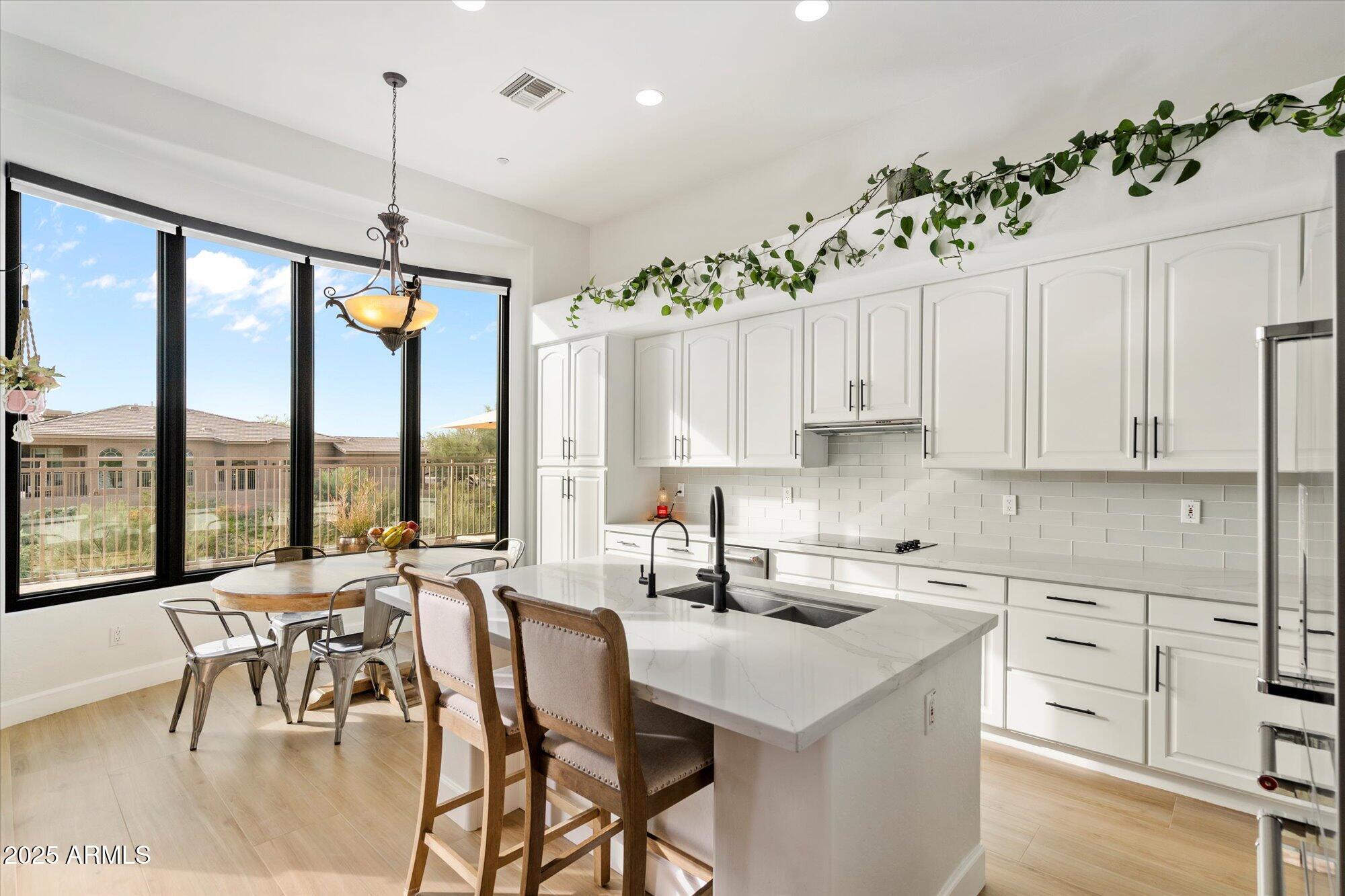 10747 East Greenway Road Scottsdale, AZ 85255 - Photo 13 of 56 a kitchen with granite countertop a stove a sink a center island and cabinets