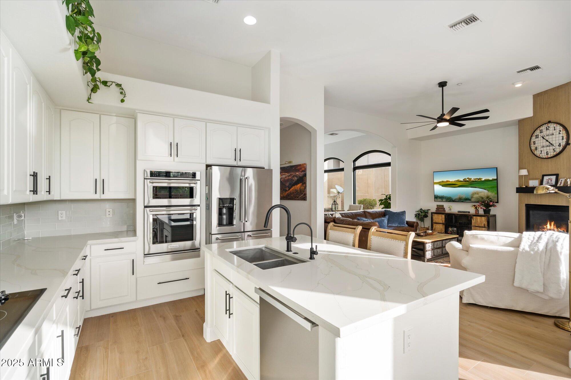 10747 East Greenway Road Scottsdale, AZ 85255 - Photo 14 of 56 a kitchen with stainless steel appliances a sink a stove and white cabinets