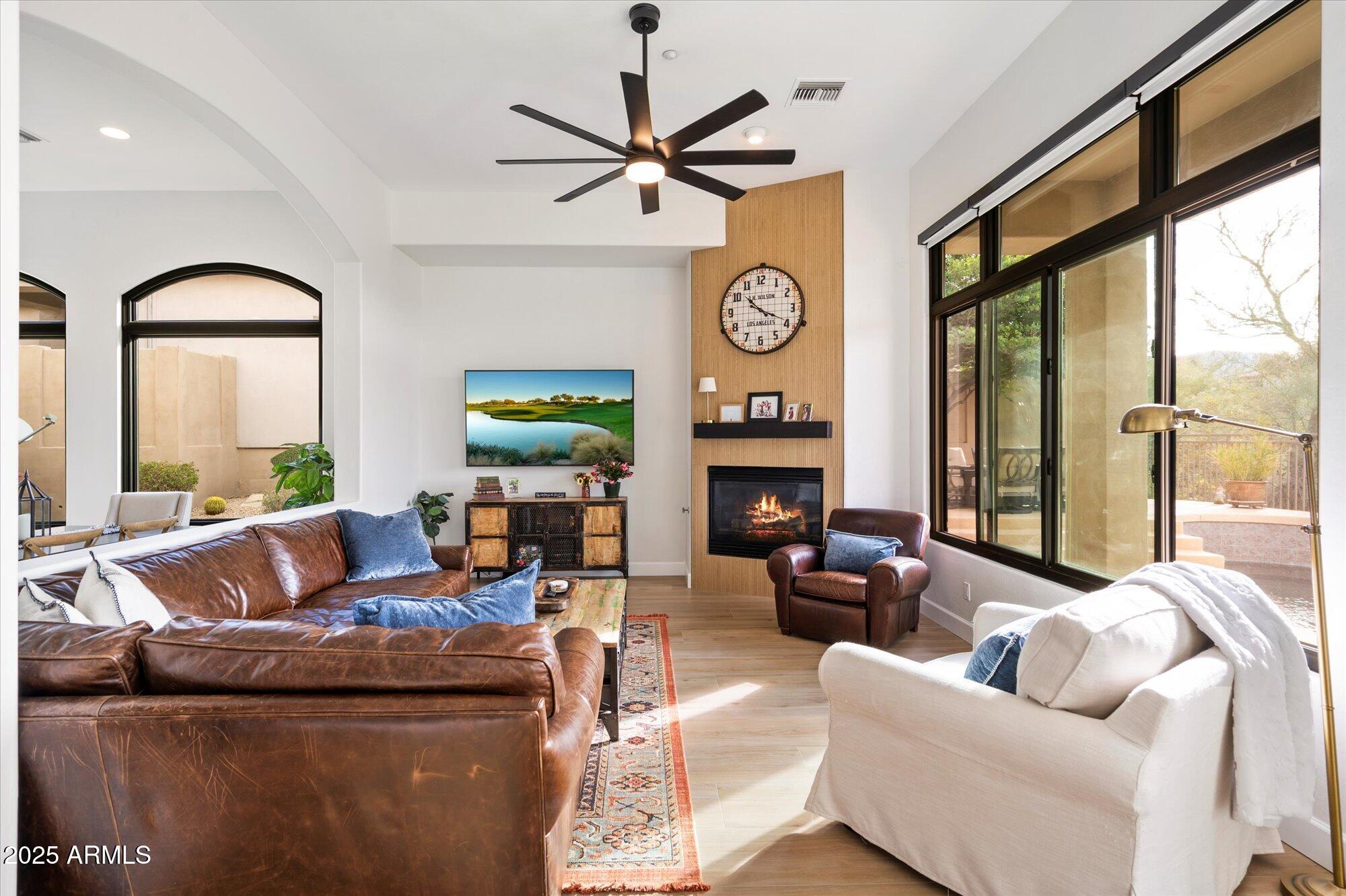 10747 East Greenway Road Scottsdale, AZ 85255 - Photo 16 of 56 a living room with fireplace furniture and a large window