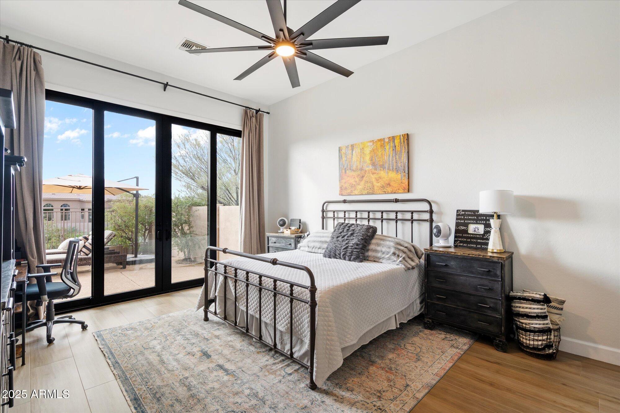 10747 East Greenway Road Scottsdale, AZ 85255 - Photo 18 of 56 a bedroom with a large bed and a large window