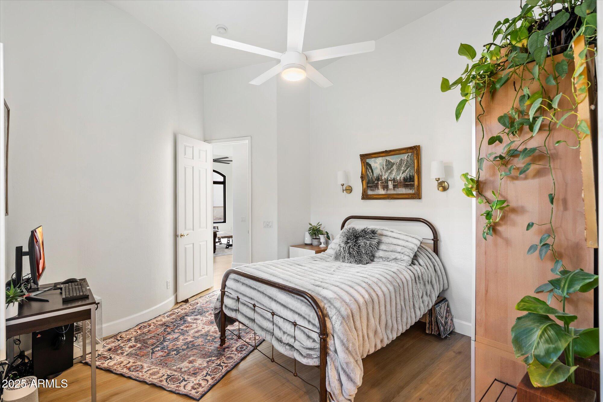 10747 East Greenway Road Scottsdale, AZ 85255 - Photo 21 of 56 a bedroom with a bed table and a couch
