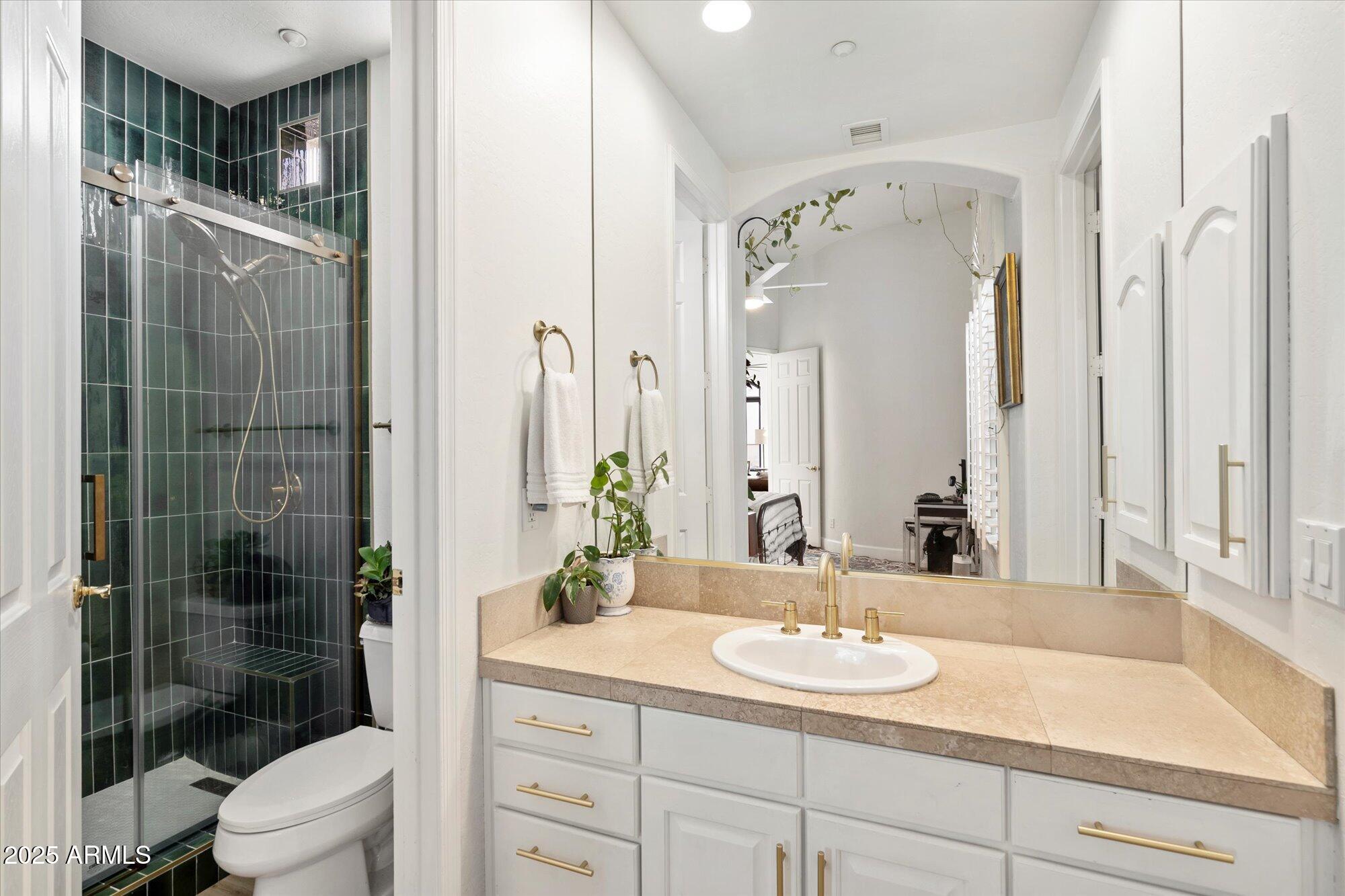 10747 East Greenway Road Scottsdale, AZ 85255 - Photo 24 of 56 a bathroom with a granite countertop sink a toilet and shower