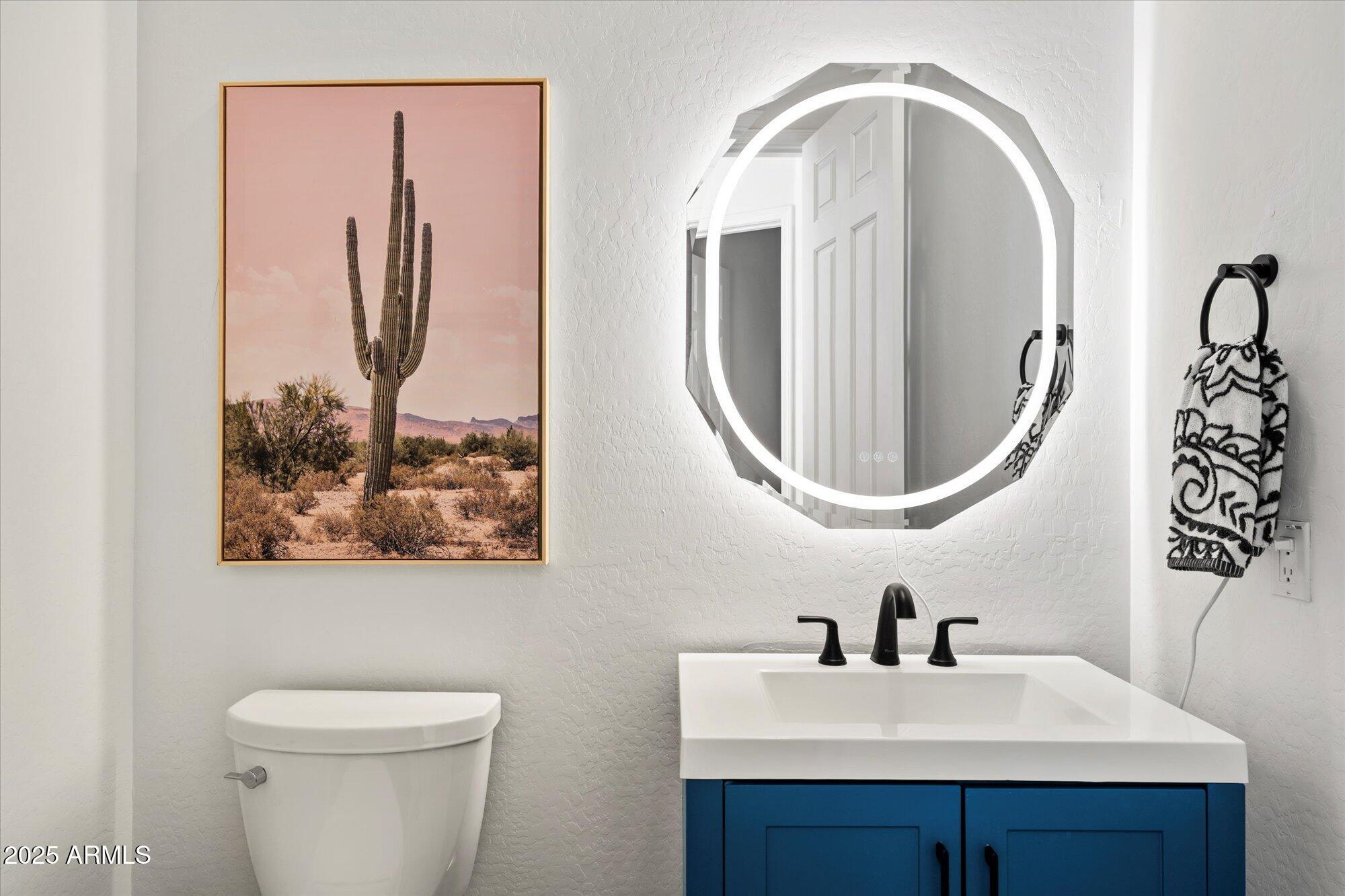 10747 East Greenway Road Scottsdale, AZ 85255 - Photo 27 of 56 a bathroom with a sink mirror and toilet