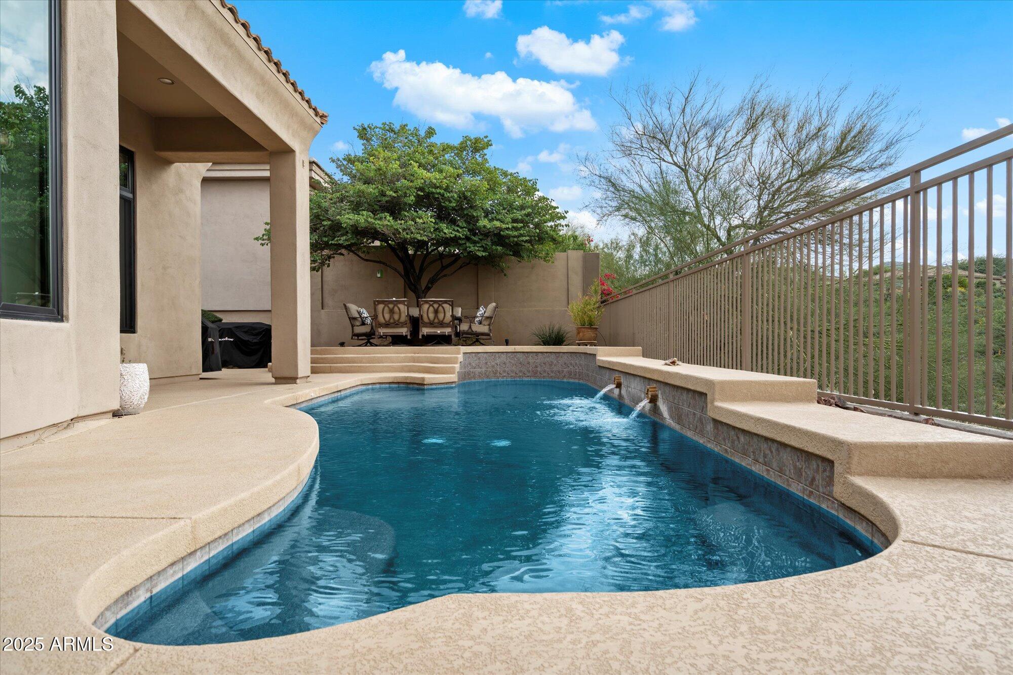 10747 East Greenway Road Scottsdale, AZ 85255 - Photo 31 of 56 a view of a swimming pool with a sitting space